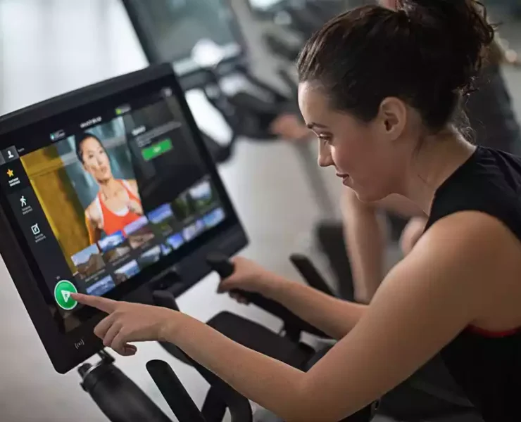 Woman using connected fitness equipment