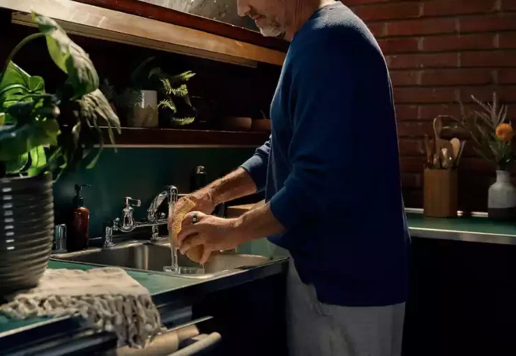 A man working in kitchen with Oura ring on his finger